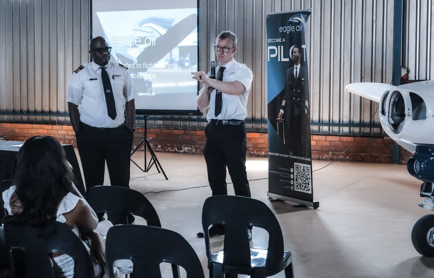 An instructor leading a briefing for students in the Eagle Air classroom