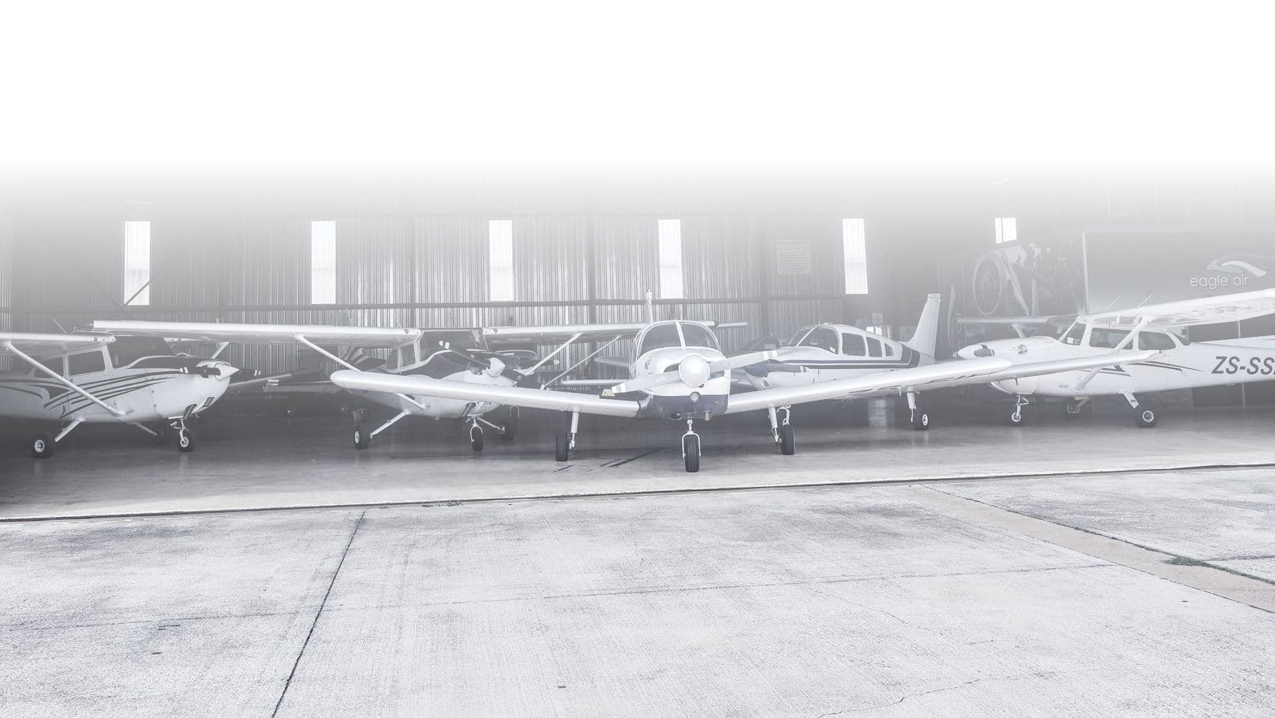 The Eagle Air training fleet lined up inside the bright hangar