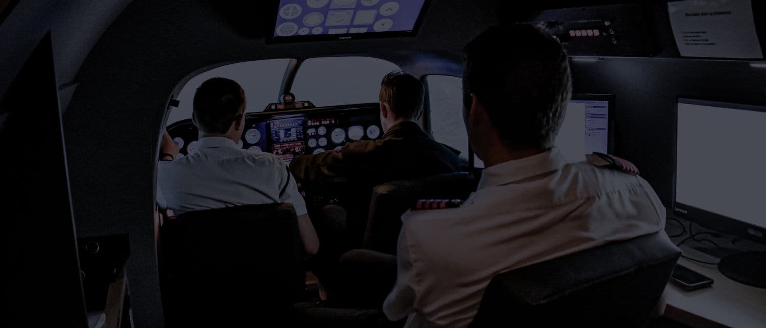 Two pilots training together in the flight simulator