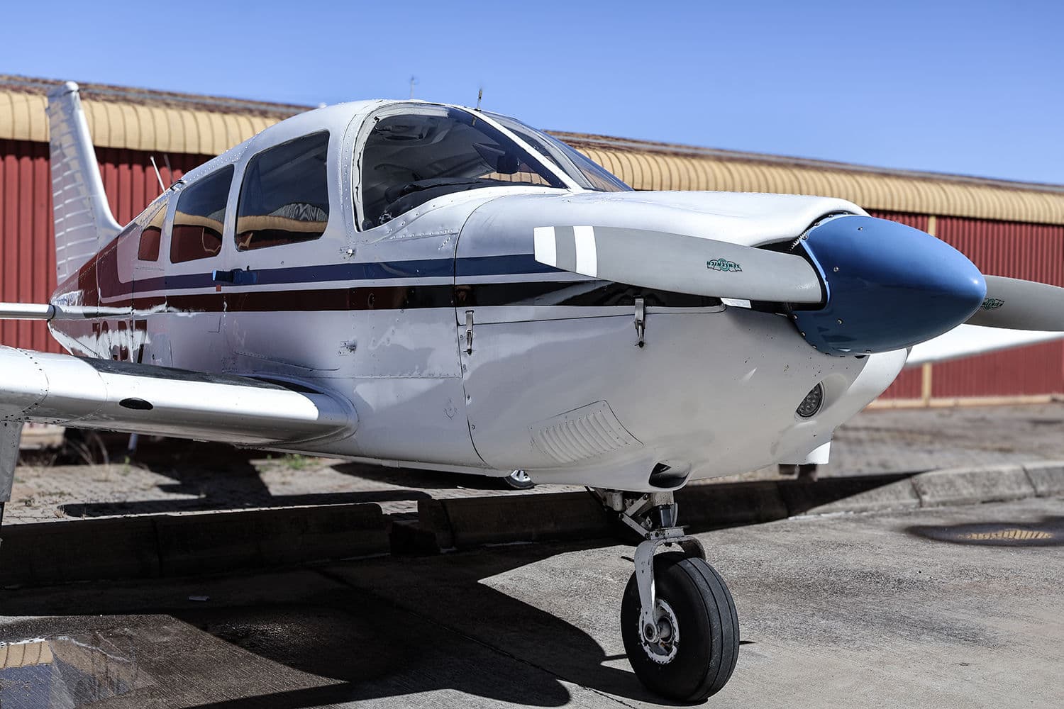A Piper Archer parked outside the Eagle Air hangar