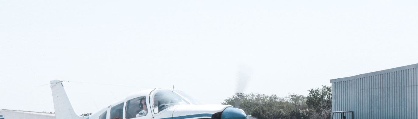A light twin taxiing past the Eagle Air hangar in daylight